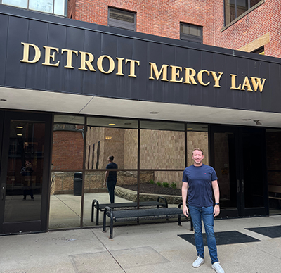 Matt Snyder under the Detroit Mercy Law sign